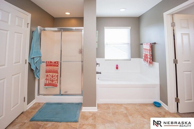 15929 Rosewater Pkwy, Bennington, NE 68007 - bathroom with a bath, a shower stall, and tile patterned flooring