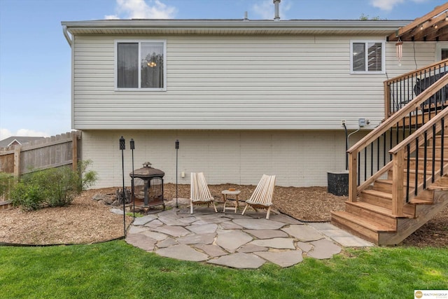15748 Rosewood St, Omaha, NE 68136 - back of property with stairway, a patio area, and brick siding