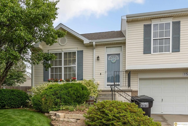 15748 Rosewood St, Omaha, NE 68136 - split level home with an attached garage and roof with shingles