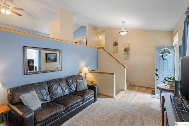 15748 Rosewood St, Omaha, NE 68136 - living room featuring vaulted ceiling, light wood finished floors, a ceiling fan, and stairs