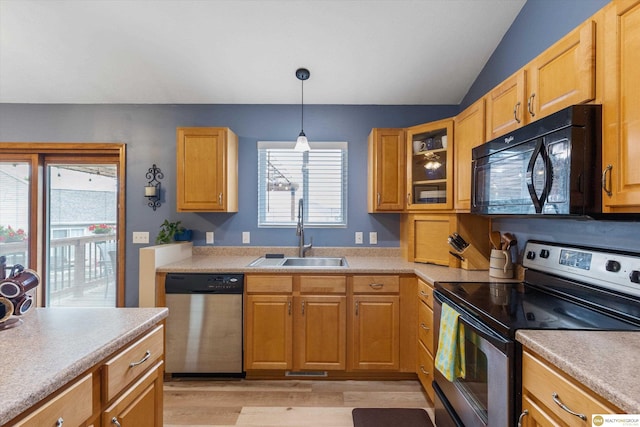 15748 Rosewood St, Omaha, NE 68136 - kitchen featuring appliances with stainless steel finishes, light wood finished floors, light countertops, hanging light fixtures, and vaulted ceiling