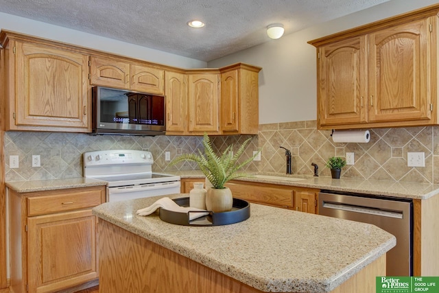 17139 S St, Omaha, NE 68135 - kitchen with stainless steel appliances, a kitchen island, a textured ceiling, decorative backsplash, and light stone counters