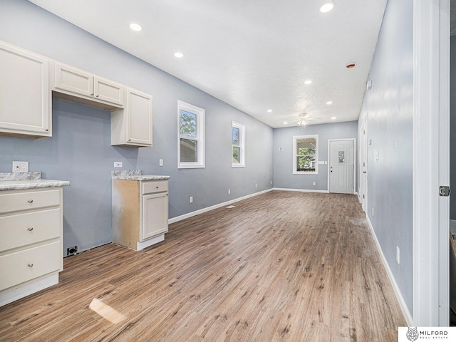 4331 N 41st St, Omaha, NE 68111 - kitchen featuring light wood-style flooring, recessed lighting, open floor plan, ceiling fan, and white cabinetry
