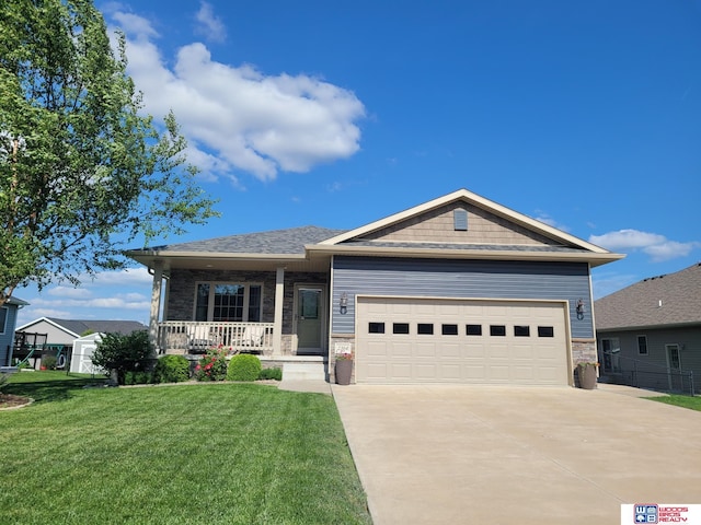 2364 N Columbia Ave, Seward, NE 68434 - view of front facade featuring covered porch, a front yard, driveway, a garage, and stone siding