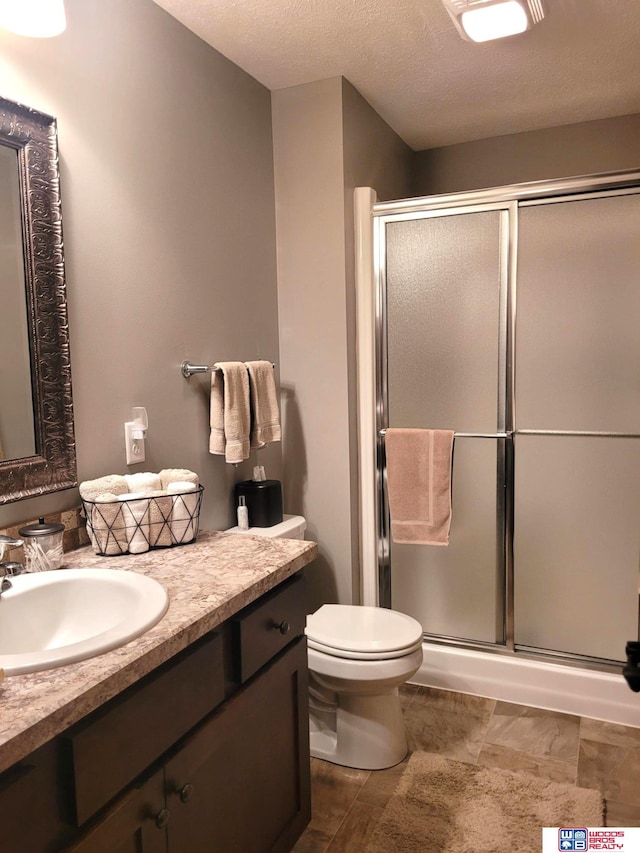 2364 N Columbia Ave, Seward, NE 68434 - full bath with vanity, a shower stall, and a textured ceiling