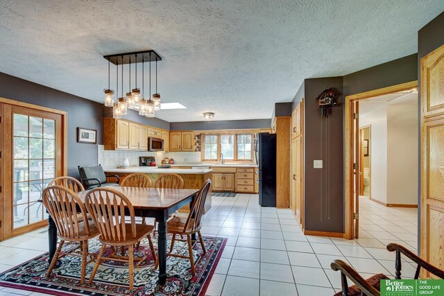 21900 Angus Rd, Gretna, NE 68028 - dining room featuring light tile patterned floors, a textured ceiling, and a chandelier