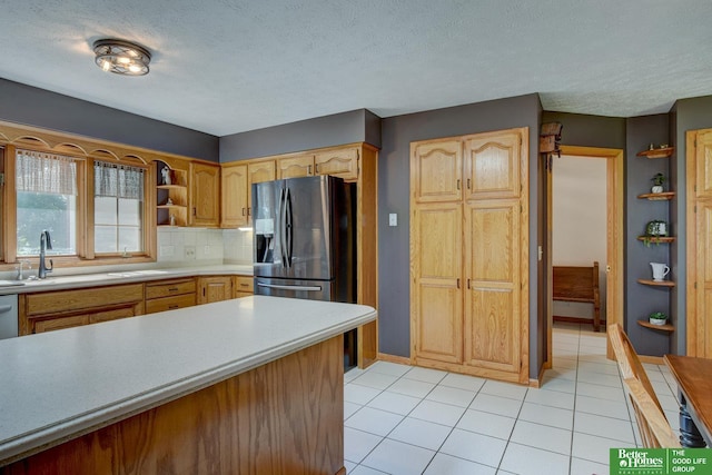 21900 Angus Rd, Gretna, NE 68028 - kitchen featuring stainless steel fridge, open shelves, light tile patterned floors, light countertops, and decorative backsplash