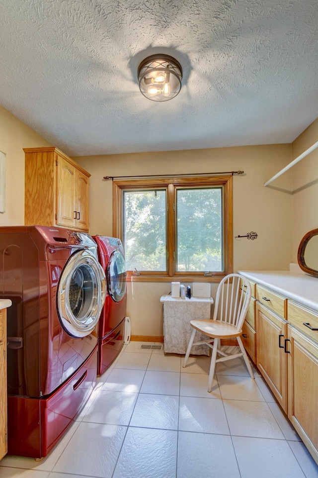21900 Angus Rd, Gretna, NE 68028 - laundry room with cabinet space, independent washer and dryer, a textured ceiling, and light tile patterned floors