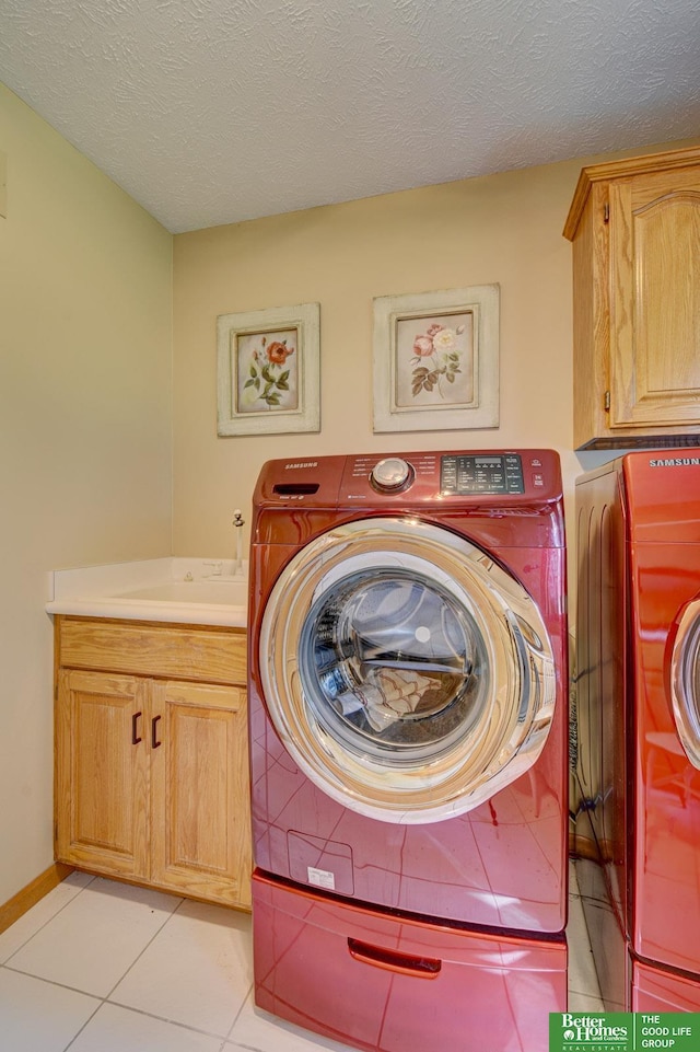21900 Angus Rd, Gretna, NE 68028 - washroom with washing machine and dryer, cabinet space, light tile patterned flooring, and a textured ceiling