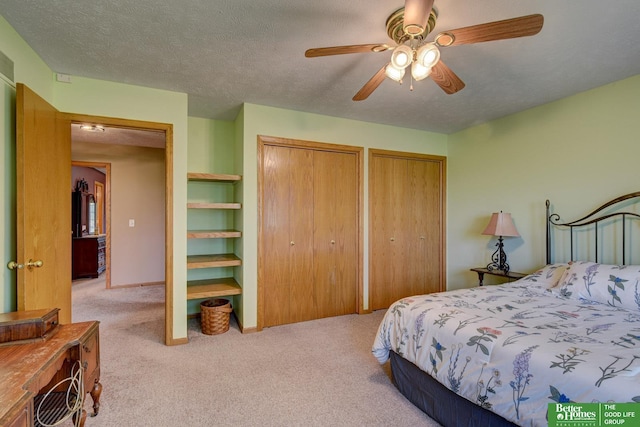 21900 Angus Rd, Gretna, NE 68028 - bedroom featuring light carpet, multiple closets, ceiling fan, and a textured ceiling
