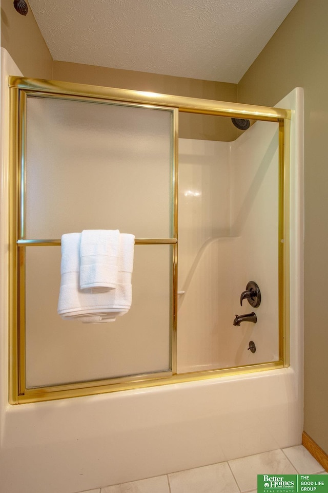 21900 Angus Rd, Gretna, NE 68028 - bathroom with shower / bath combination with glass door, tile patterned floors, and a textured ceiling