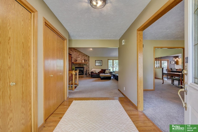 21900 Angus Rd, Gretna, NE 68028 - hallway with a textured ceiling, light wood-style flooring, and light colored carpet