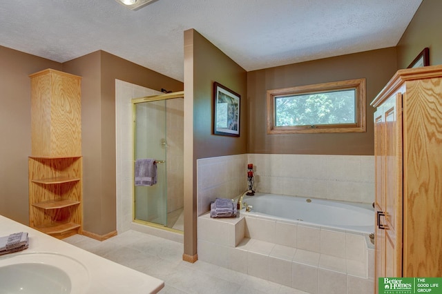 21900 Angus Rd, Gretna, NE 68028 - bathroom with a bath, a stall shower, tile patterned floors, double vanity, and a textured ceiling