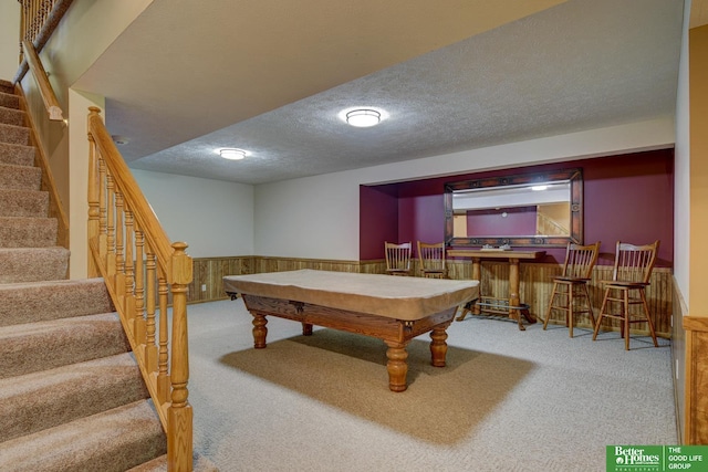 21900 Angus Rd, Gretna, NE 68028 - rec room featuring carpet flooring, a bar, a wainscoted wall, pool table, and a textured ceiling