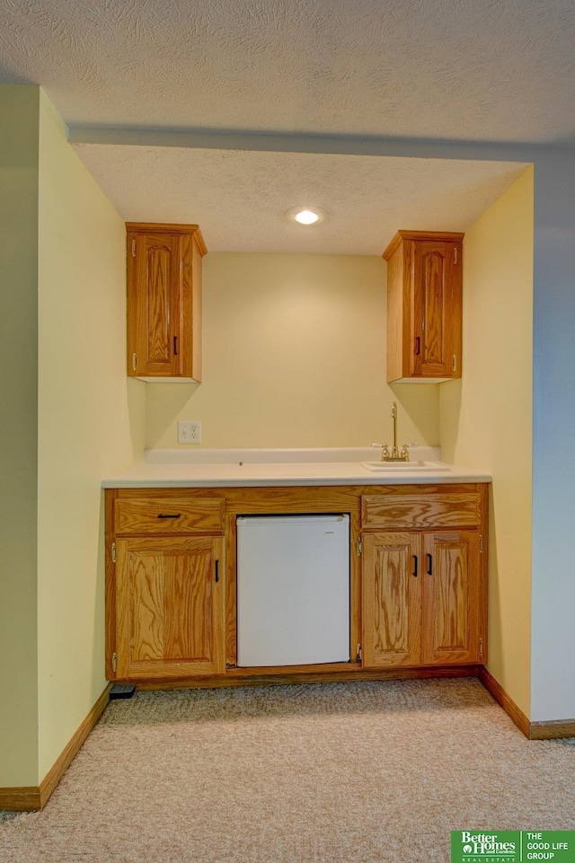 21900 Angus Rd, Gretna, NE 68028 - kitchen featuring dishwasher, light carpet, light countertops, a textured ceiling, and recessed lighting