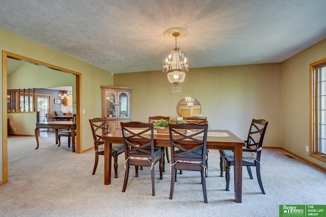 21900 Angus Rd, Gretna, NE 68028 - dining room featuring a chandelier, light colored carpet, and plenty of natural light