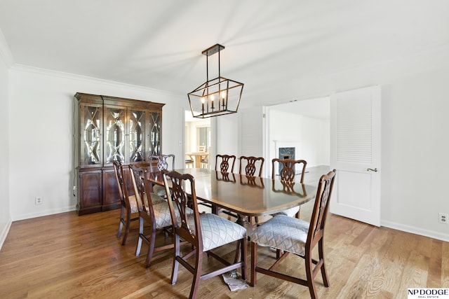 1705 N 102nd St, Omaha, NE 68114 - dining area featuring crown molding, light wood-style floors, and a chandelier