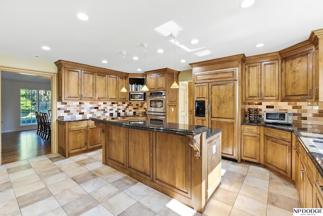 1705 N 102nd St, Omaha, NE 68114 - kitchen featuring brown cabinets, a center island, built in appliances, decorative backsplash, and recessed lighting