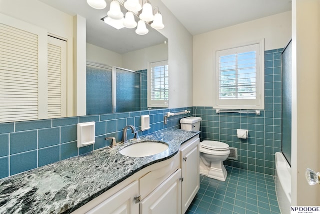 1705 N 102nd St, Omaha, NE 68114 - bathroom featuring tile patterned floors, tile walls, vanity, a chandelier, and wainscoting