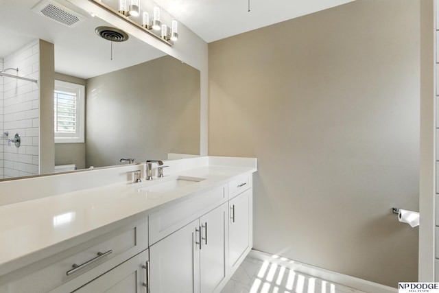 1705 N 102nd St, Omaha, NE 68114 - bathroom featuring vanity, a tile shower, and marble look tiles
