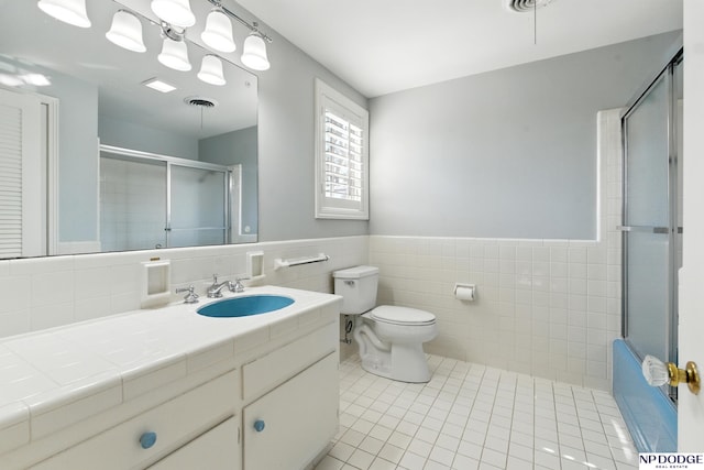 1705 N 102nd St, Omaha, NE 68114 - bathroom featuring vanity, tile patterned floors, tile walls, and a wainscoted wall