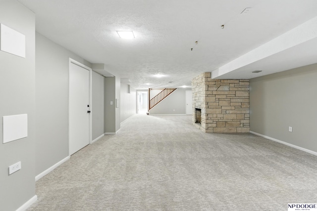 1705 N 102nd St, Omaha, NE 68114 - finished below grade area featuring a stone fireplace, carpet floors, a textured ceiling, and stairs