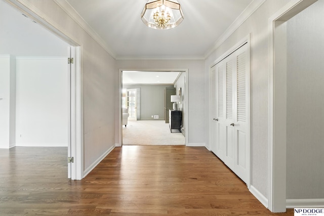 1705 N 102nd St, Omaha, NE 68114 - hallway featuring crown molding, a chandelier, and wood finished floors