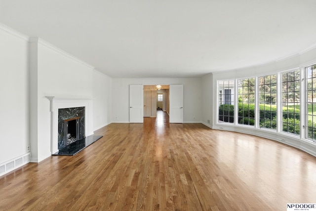 1705 N 102nd St, Omaha, NE 68114 - unfurnished living room featuring wood finished floors, a premium fireplace, and ornamental molding