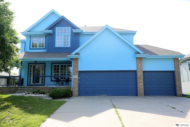 11915 S 53rd St, Papillion, NE 68133 - view of front of home featuring concrete driveway, a garage, a porch, and a shingled roof