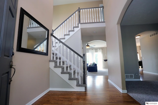 11915 S 53rd St, Papillion, NE 68133 - entrance foyer with arched walkways, ceiling fan, wood finished floors, and a towering ceiling