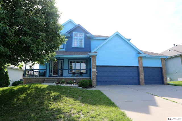 11915 S 53rd St, Papillion, NE 68133 - view of front facade featuring driveway, a porch, an attached garage, brick siding, and a front lawn