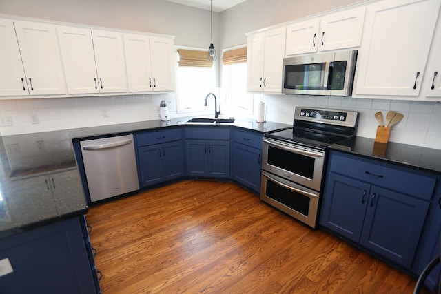 11915 S 53rd St, Papillion, NE 68133 - kitchen with appliances with stainless steel finishes, blue cabinets, white cabinets, decorative light fixtures, and dark wood-style flooring