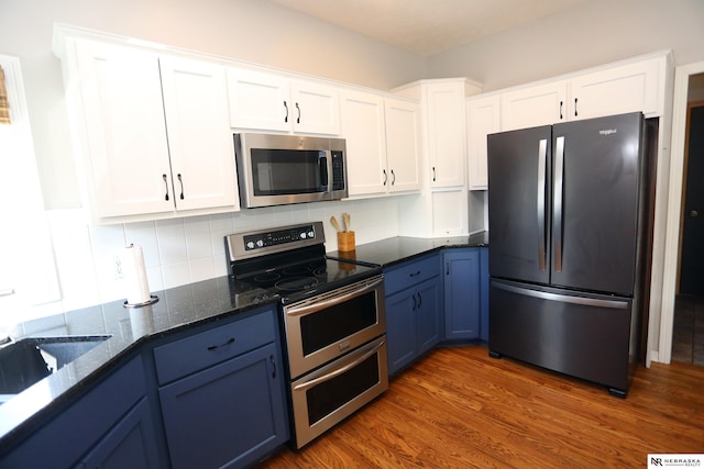 11915 S 53rd St, Papillion, NE 68133 - kitchen featuring appliances with stainless steel finishes, blue cabinets, white cabinets, and wood finished floors