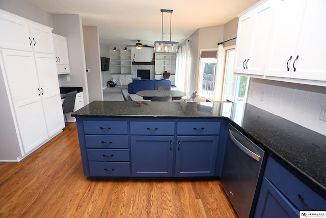 11915 S 53rd St, Papillion, NE 68133 - kitchen with dishwasher, a peninsula, a ceiling fan, a fireplace, and backsplash