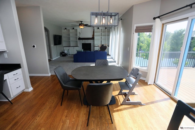 11915 S 53rd St, Papillion, NE 68133 - dining room with a ceiling fan, wood finished floors, and a fireplace