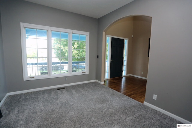 11915 S 53rd St, Papillion, NE 68133 - foyer with dark colored carpet and arched walkways