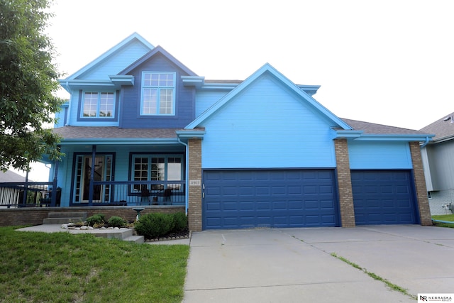11915 S 53rd St, Papillion, NE 68133 - view of front of home with concrete driveway, a garage, a porch, brick siding, and roof with shingles