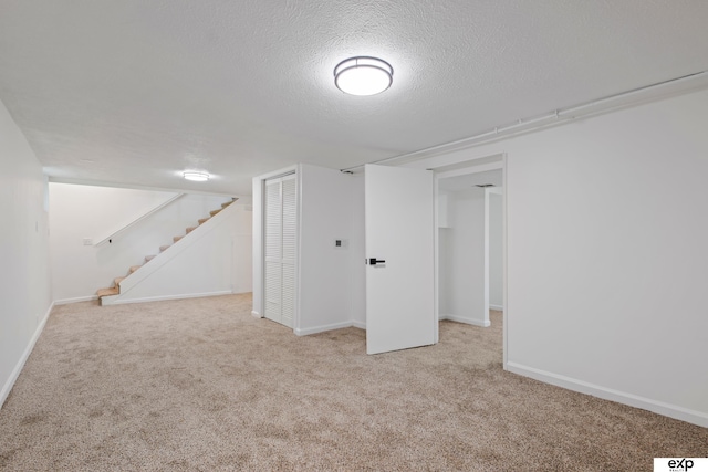 3279 Hascall St, Omaha, NE 68105 - finished below grade area featuring carpet, stairway, and a textured ceiling