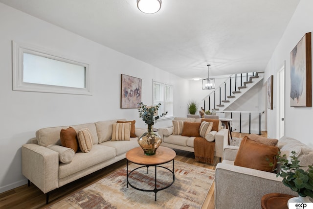 3279 Hascall St, Omaha, NE 68105 - living area featuring wood finished floors, stairway, and a chandelier