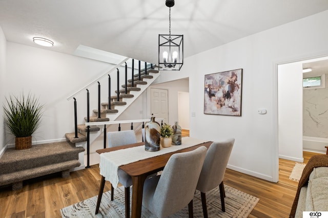 3279 Hascall St, Omaha, NE 68105 - dining room featuring stairway, a chandelier, and wood finished floors