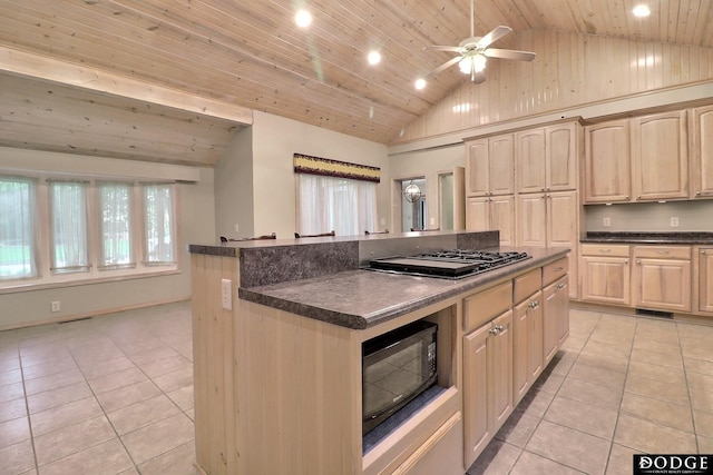 405 W 20th St, Fremont, NE 68025 - kitchen with black microwave, light tile patterned flooring, gas cooktop, dark countertops, and ceiling fan