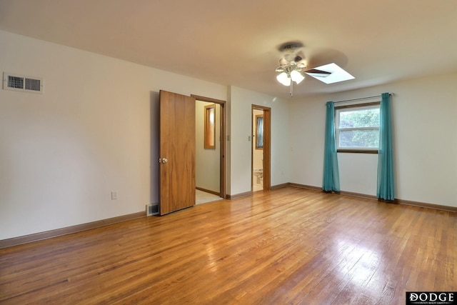 405 W 20th St, Fremont, NE 68025 - unfurnished room with light wood-style floors, a ceiling fan, and a skylight