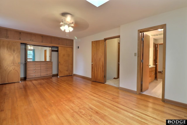 405 W 20th St, Fremont, NE 68025 - unfurnished bedroom with light wood-style flooring, a closet, and a skylight