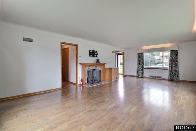 405 W 20th St, Fremont, NE 68025 - unfurnished living room featuring wood finished floors, a premium fireplace, and ornamental molding