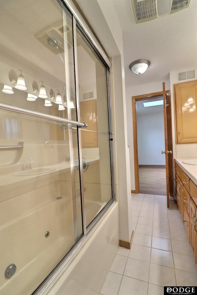 405 W 20th St, Fremont, NE 68025 - bathroom with tile patterned floors, vanity, and bath / shower combo with glass door