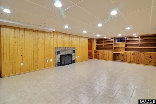 405 W 20th St, Fremont, NE 68025 - unfurnished living room with a brick fireplace, recessed lighting, wood walls, and built in shelves