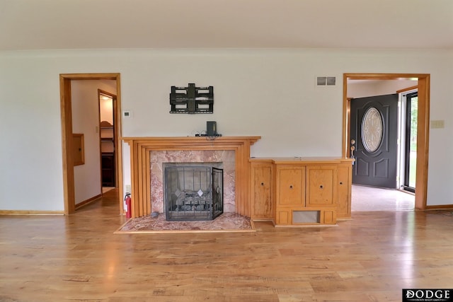 405 W 20th St, Fremont, NE 68025 - unfurnished living room with a high end fireplace, light wood-style flooring, and crown molding