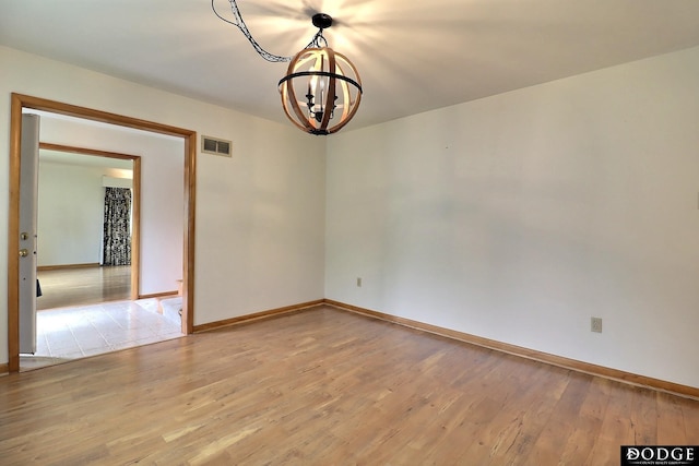 405 W 20th St, Fremont, NE 68025 - spare room featuring a chandelier and light wood-style floors
