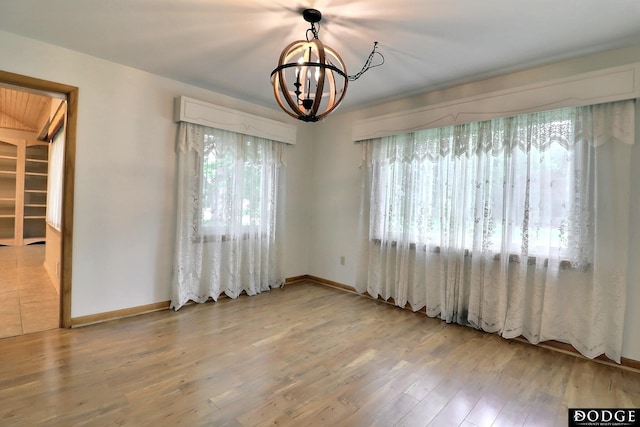 405 W 20th St, Fremont, NE 68025 - spare room featuring a chandelier and wood finished floors