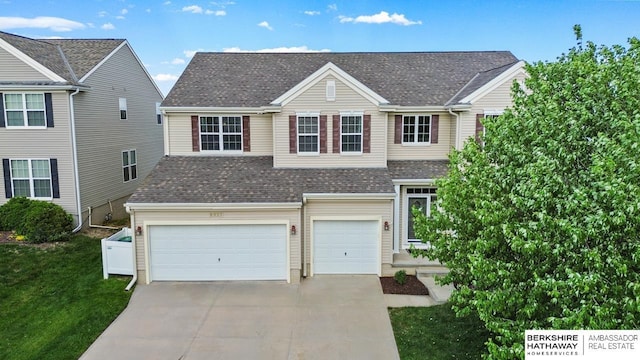 8917 N 157th St, Bennington, NE 68007 - traditional home featuring concrete driveway, an attached garage, a shingled roof, and a front yard